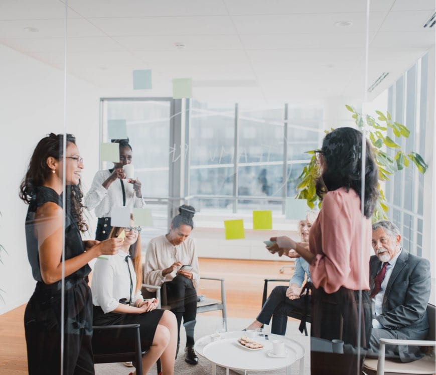 Group Of People Brainstorming New Business Ideas And Using Sticky Note