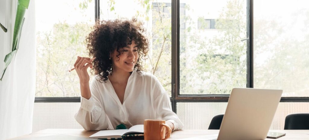 Young african american woman studying at home with laptop