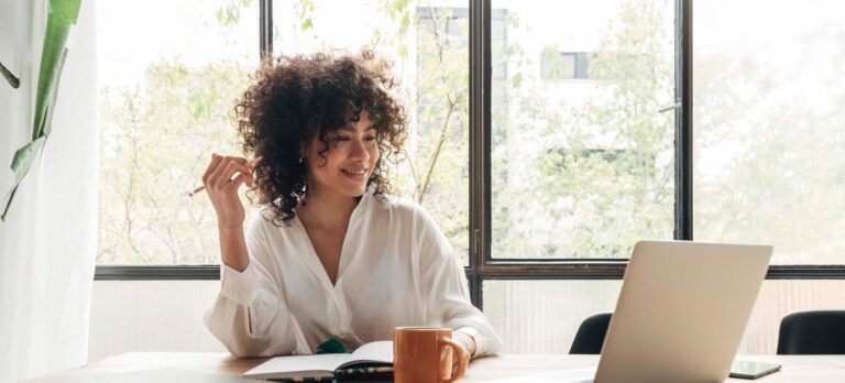 Young african american woman studying at home with laptop