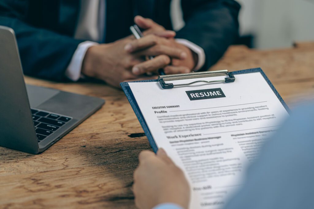 Hiring concept HR manager is interviewing a job candidate filling out a resume on a job application form to be considered for a job