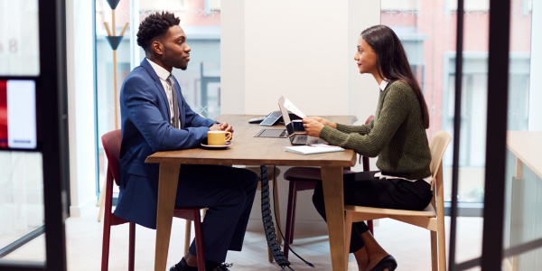 Colleagues talking at a table