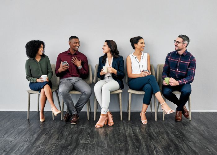 5 coworkers sitting and talking together