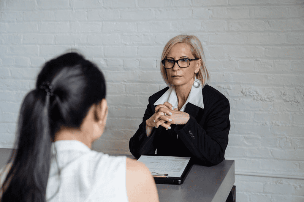 blonde woman sitting with her hands together 