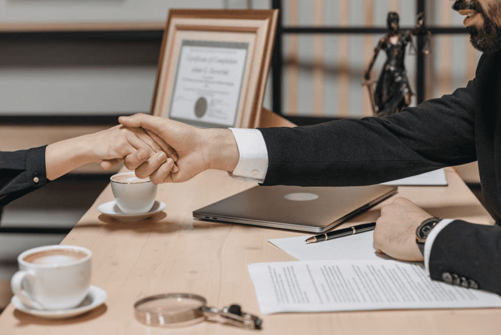 people shaking their hands in close deal business contract 
