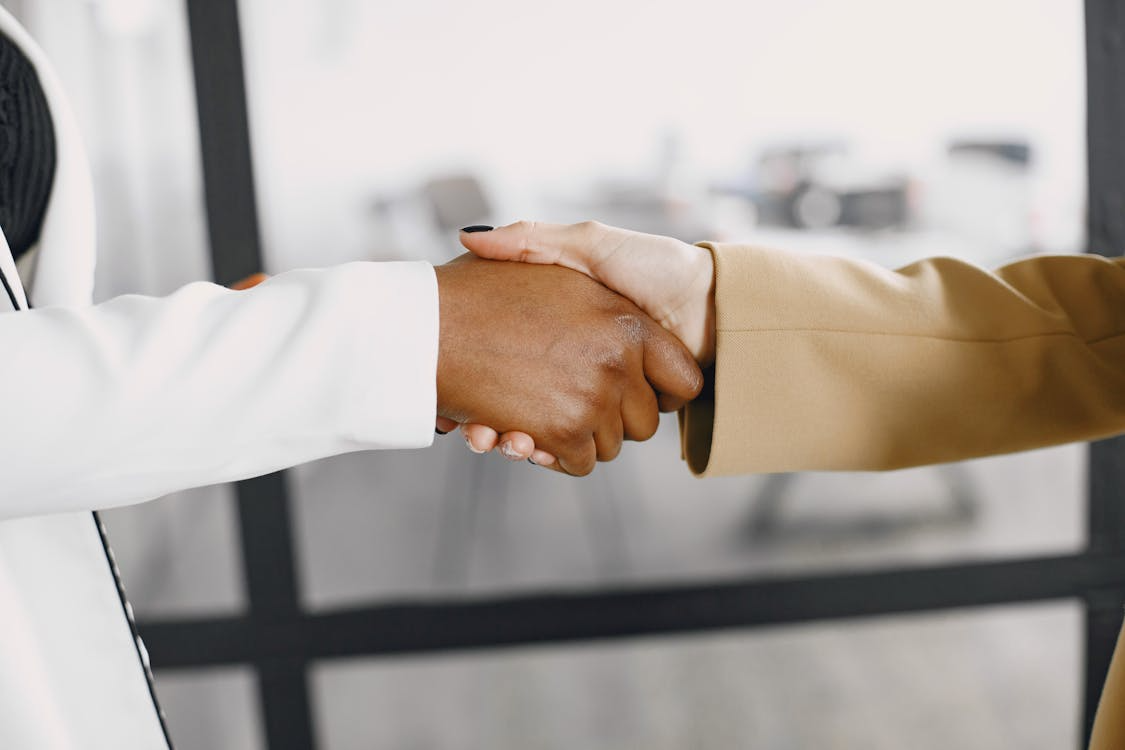Legal professional shaking hands with a recruiter after a successful law firm interview